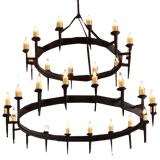 A large, two-tier chandelier featuring circular wrought iron frames adorned with multiple candle-like lights. Each frame is elegantly designed with a rustic finish, casting a warm and inviting glow, perfect for enhancing the ambiance of any space.
